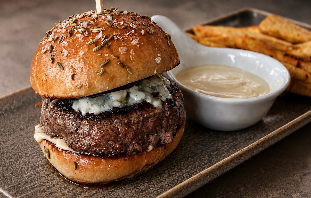 The Prime Brisket Pub Burger on a fennel-seed bun with blue cheese, aioli, and hand-cut fries